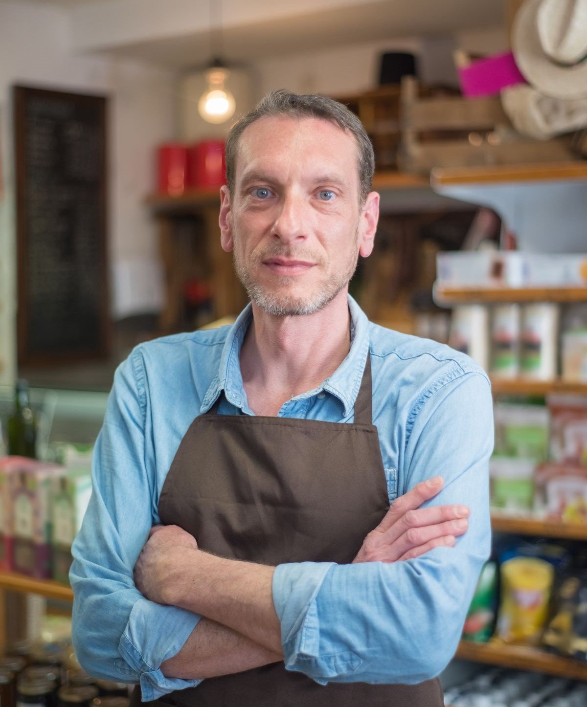 A local business owner standing in front of their storefront